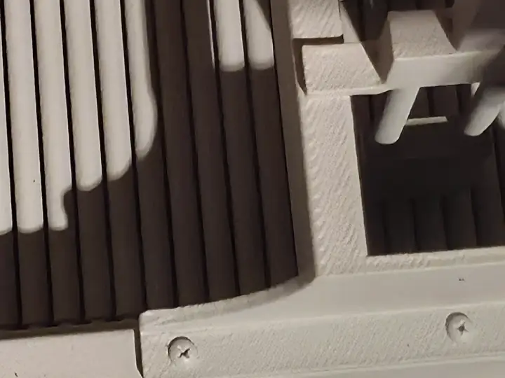 Close-up reference photograph of printed ribs, fasteners, and internal detail on an industrial model.
